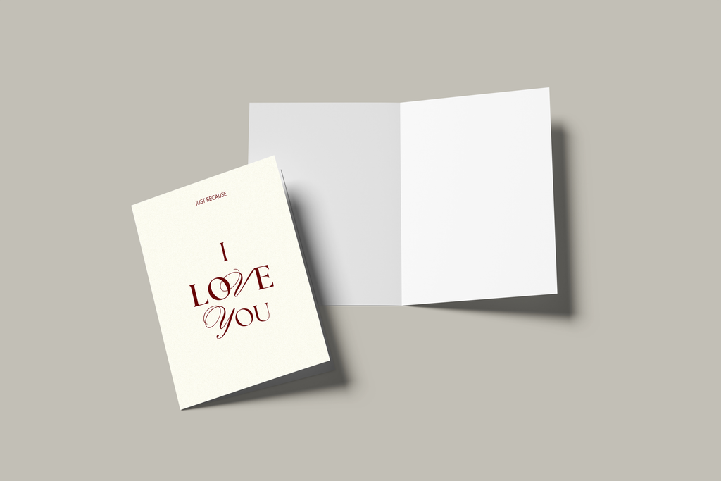 Open cream card with ‘I LOVE YOU’ embossed in burgundy serif